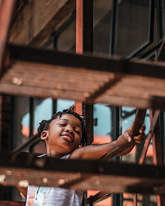 tilt shift lens photography of girl standing on gray stair thumbnail