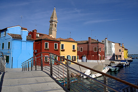 blue, brown, and yellow concrete house near the body of water at daytime thumbnail