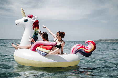 Two Women On Unicorn Floater On Sea thumbnail
