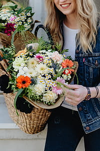 Young woman with basket full of flowers thumbnail