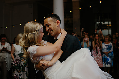 groom carrying bride while facing each other thumbnail