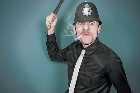 man wearing police costume holding baton and smoking cigarette thumbnail