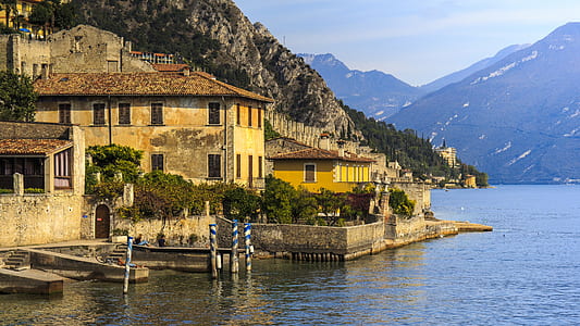 beige concrete houses near body of water thumbnail