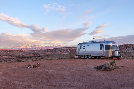 gray camper trailer parked on open field at daytime thumbnail