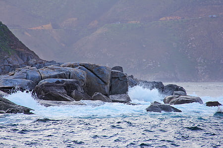gray boulder on seashore thumbnail