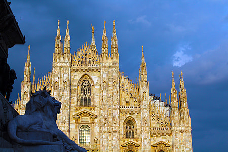 brown and white concrete cathedral under gray sky thumbnail