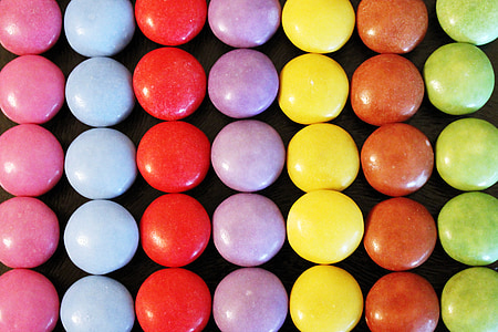 assorted-color candy lot on black surface thumbnail