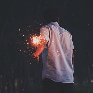 man holding lighted sparkler thumbnail