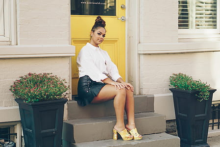 woman sitting on staircase at daytime thumbnail