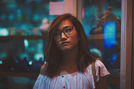 woman wearing eyeglasses near glass door thumbnail