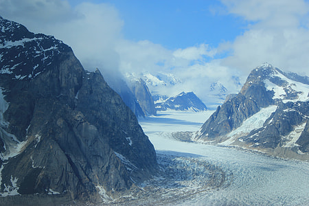 mountains covered with snow under cloudy sky thumbnail