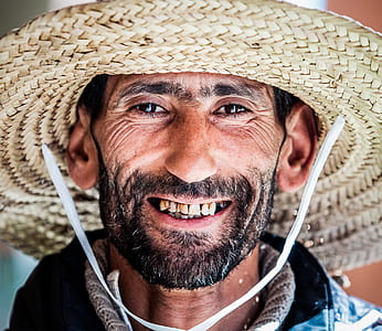 man wearing brown hat smiling while taking picture thumbnail