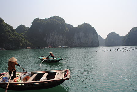 person paddling boat while standing on it thumbnail