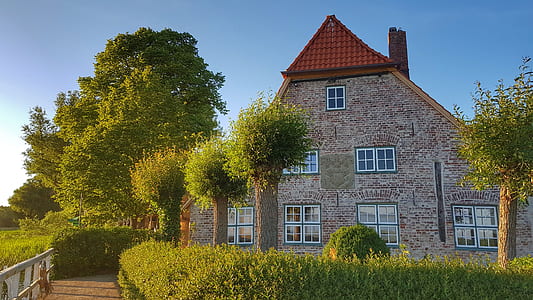 brown and red house beside trees thumbnail