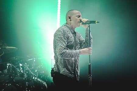 Man Wearing Gray Button-up Dress Shirt Holding Black Cordless Microphone With Stand thumbnail