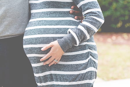 woman wearing gray and white striped maternity dress thumbnail