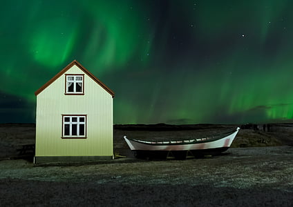 white and brown house near white canoe boat thumbnail