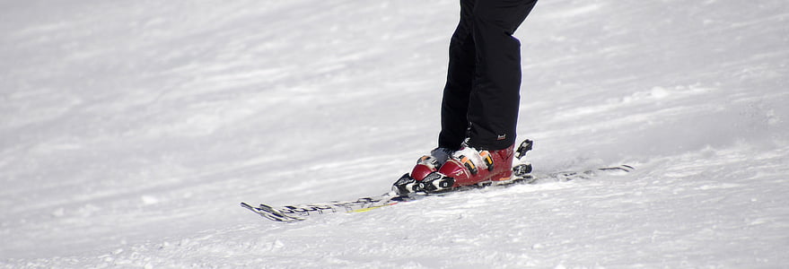 person riding pair of red-and-gray ice skates thumbnail