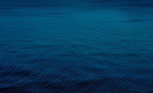 aerial of calm ocean waters thumbnail