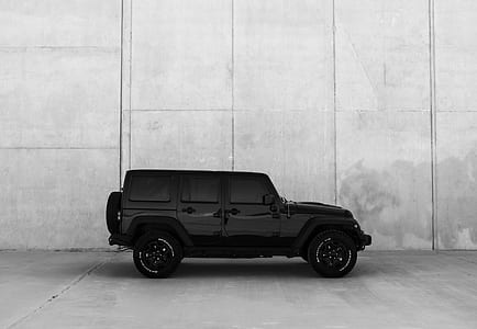 black Jeep Wrangler SUV near gray wall thumbnail