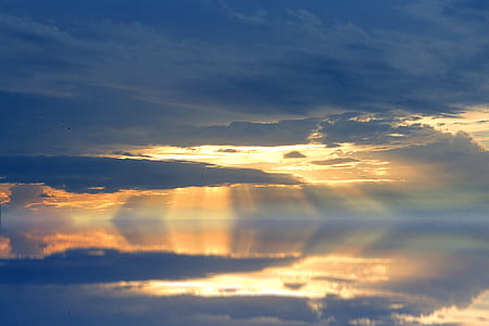 body of water under cloudy sky thumbnail