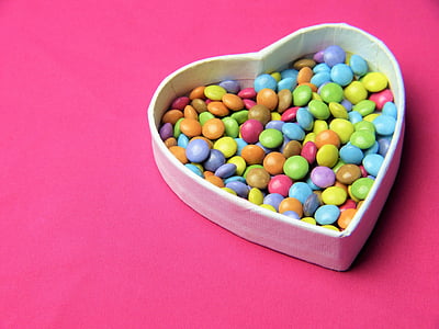assorted-color candies in heart-shaped box thumbnail