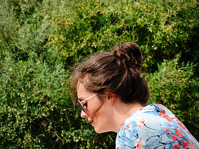 woman wearing floral top near green leafed plants at daytime thumbnail