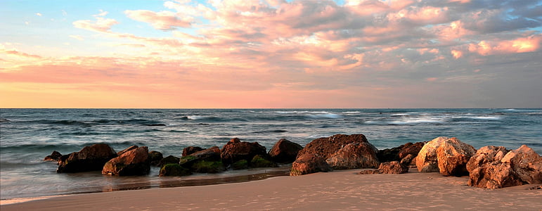 brown stones on seashore during sunrise thumbnail