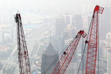 aerial photo of tower cranes beside high rise buildings thumbnail