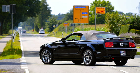 black coupe on road thumbnail