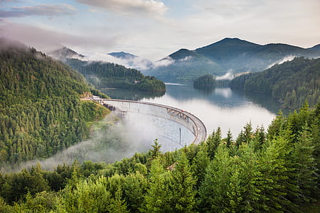 aerial photography of railroad surrounded with body of water thumbnail