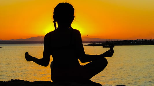 silhouette of woman near ocean during susnet thumbnail