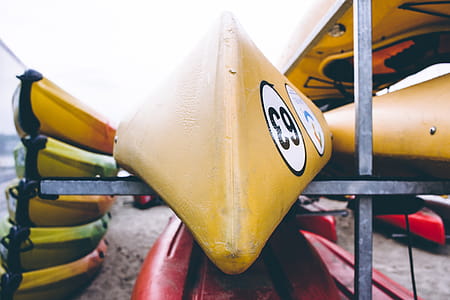 Closeup Photo of Yellow Kayak on Gray Metal Rack thumbnail