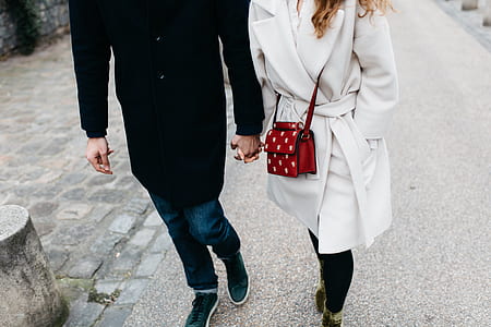 man holding woman's hand thumbnail
