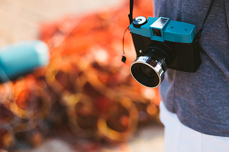 camera hanging in front of blue cloth thumbnail