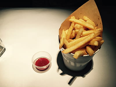 french fries beside ketchup on white surface thumbnail