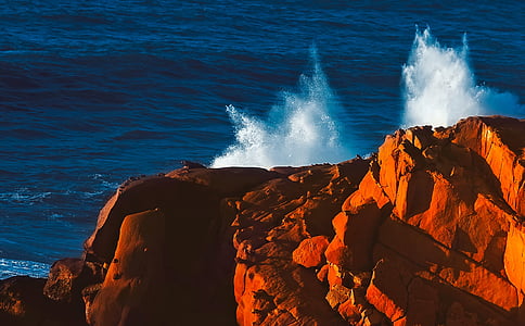 water splashing through brown cliff thumbnail