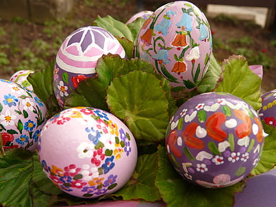 five assorted-color easter eggs on green leaves thumbnail