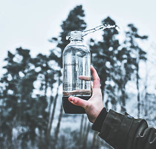 person holding sports bottle filled with water thumbnail