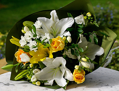 close up photo of yellow roses and white lilies bouquet thumbnail