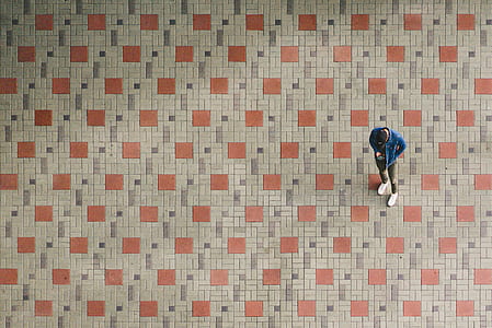 man wearing blue jacket holding smartphone thumbnail