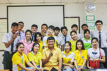 teacher and students photo in front of white board thumbnail