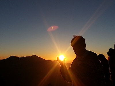 silhouette photo of man lifting his hands thumbnail