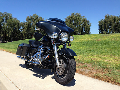 black touring motorcycle near on the green grass thumbnail