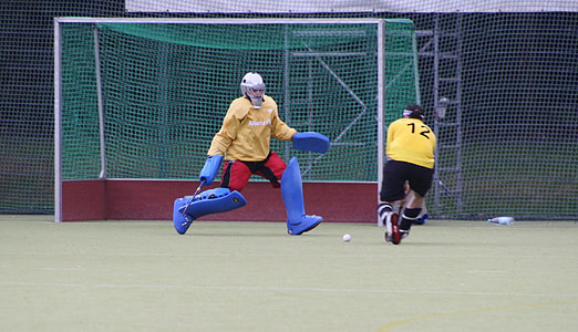 two men playing field hockey thumbnail
