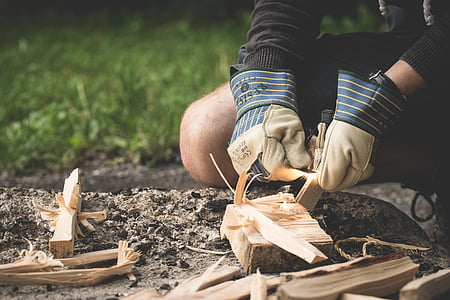 person igniting woods for fire thumbnail