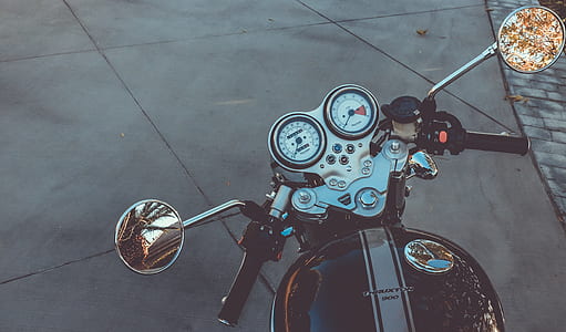 black motorcycle parked on tile flooring thumbnail