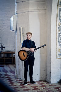 Man Holding Acoustic Guitar thumbnail