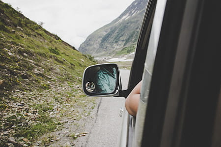 gray vehicle beside mountain thumbnail