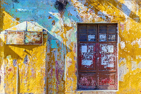 yellow painted building with red wooden doors thumbnail